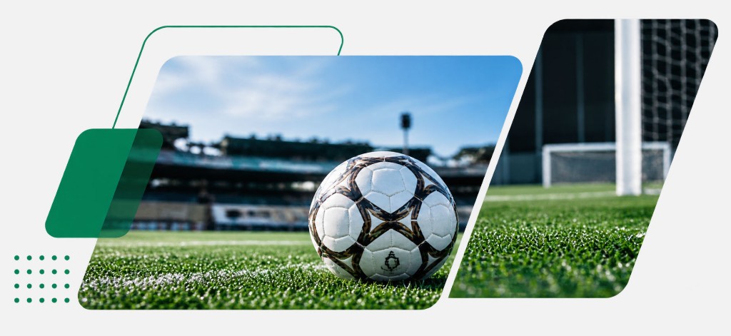 A football on the pitch in front of a goal.